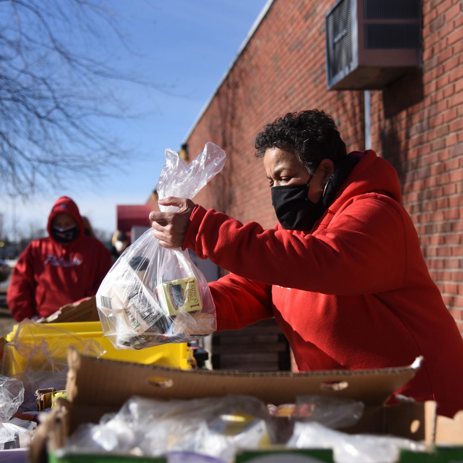 Old Colony YMCA employee distributes food to the community